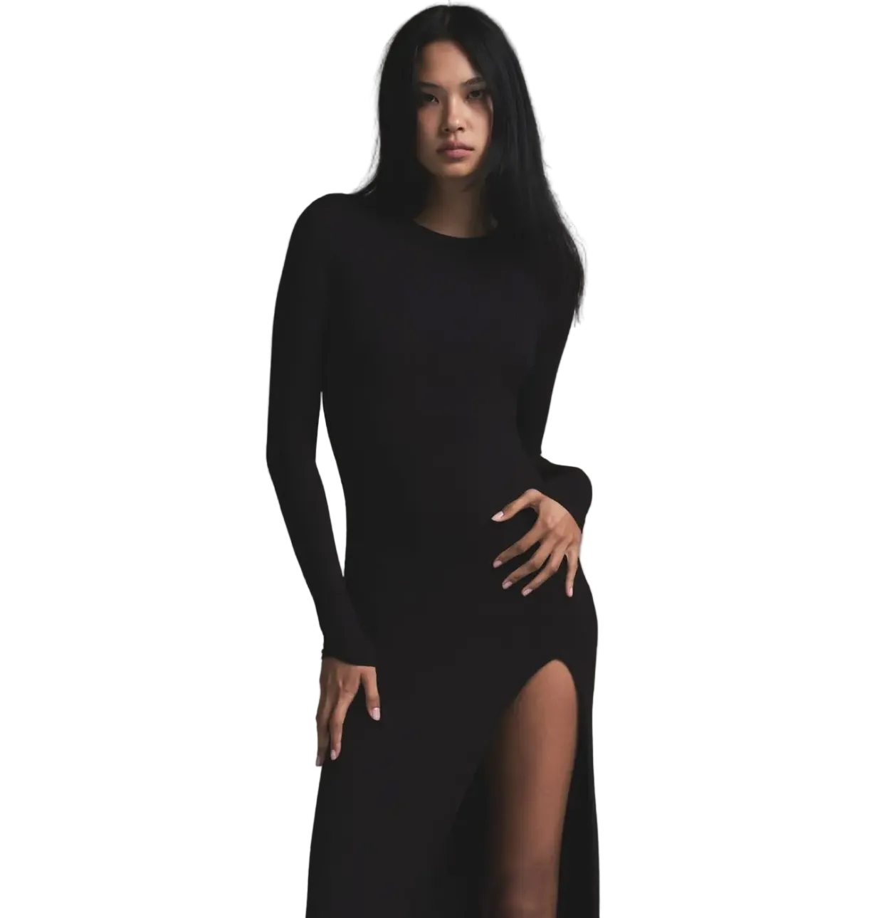 Woman wearing a black dress with a slit on a gray background