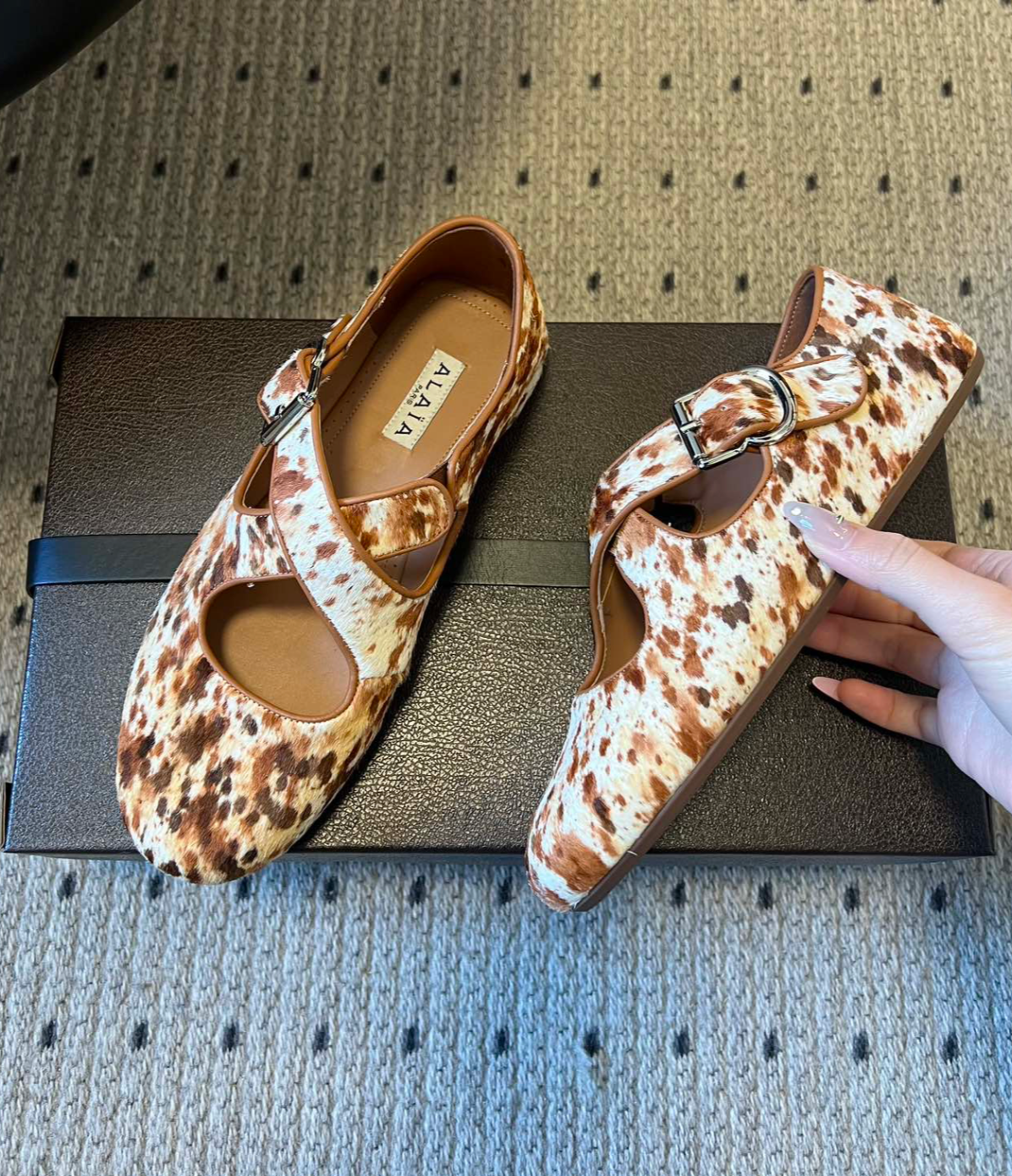 ALAÏA COW PRINT CRISS CROSS BALLET FLATS IN HAIRCALF