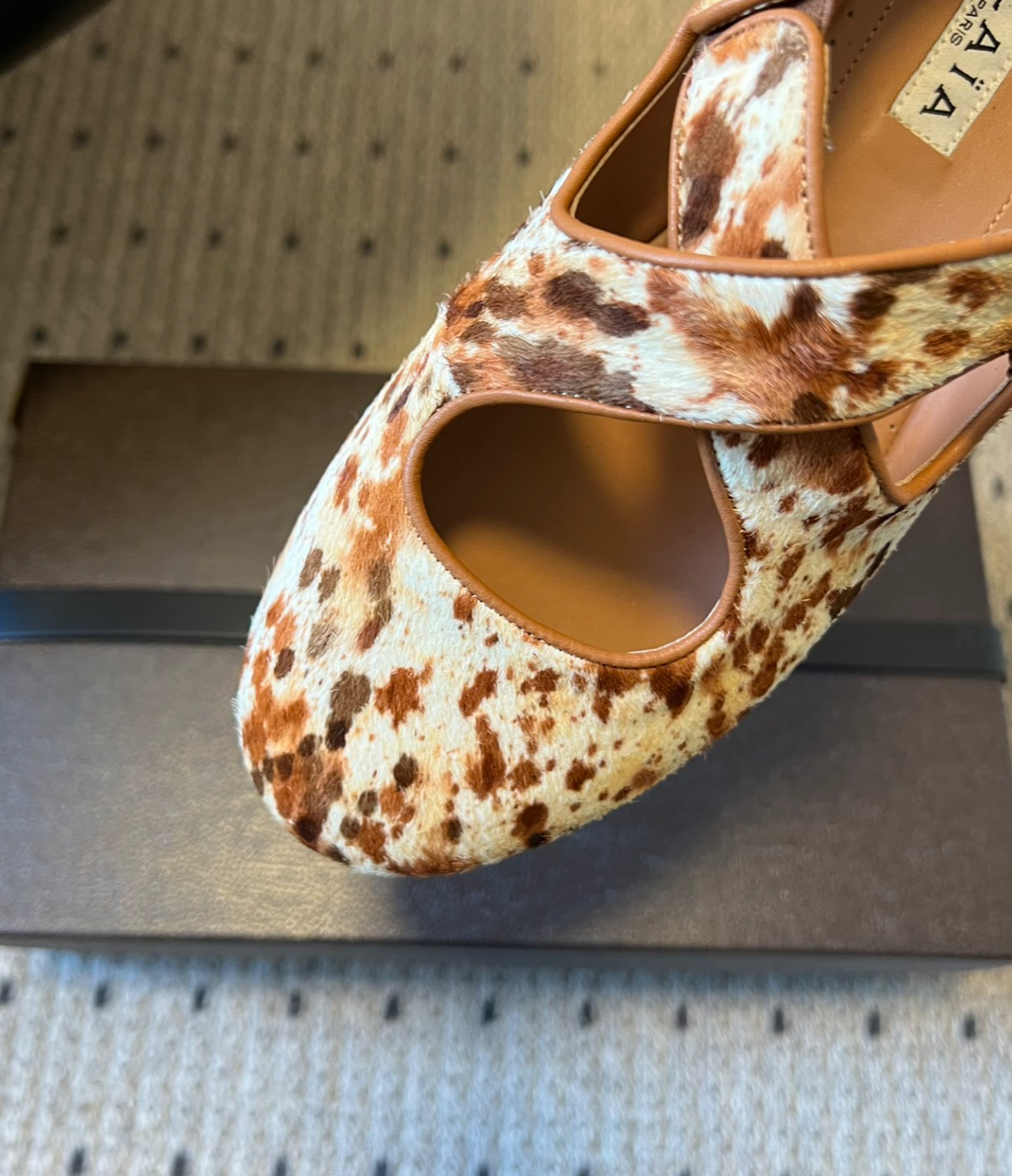 ALAÏA COW PRINT CRISS CROSS BALLET FLATS IN HAIRCALF